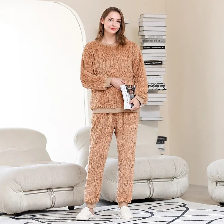 femme portant un pyjama plaid cocooning debout devant une pile de livre