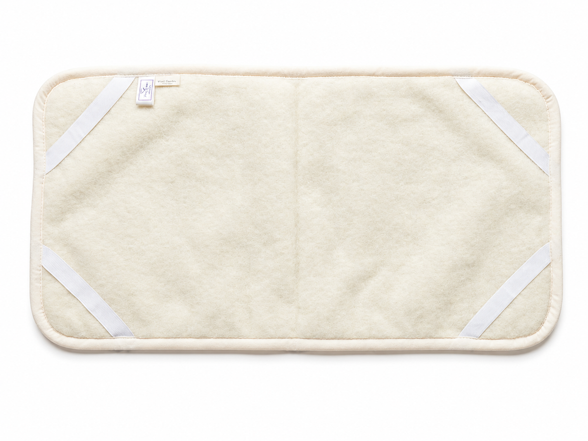 Surmatelas en laine pour berceau et poussette blanc cassé, dessous avec les élastiques aux quatre coins